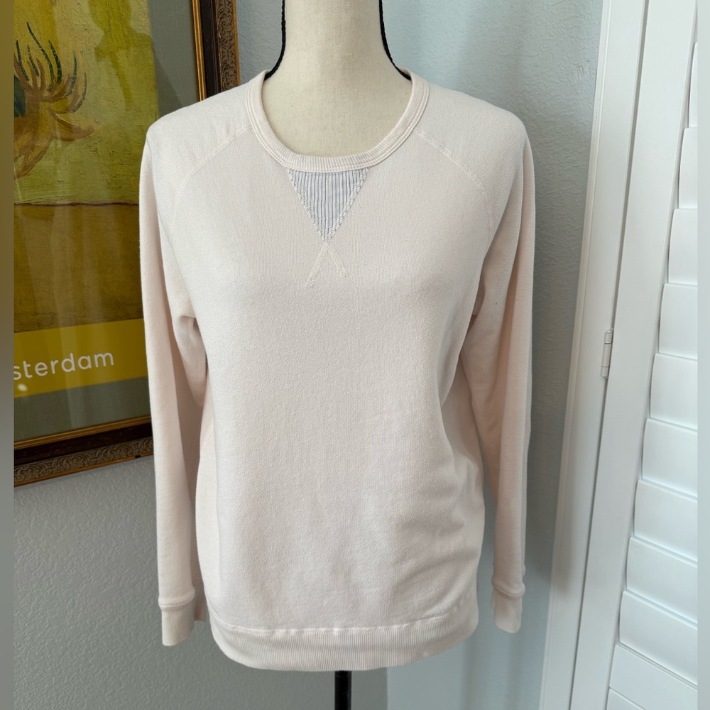 Light pink, lightweight sweatshirt top.
